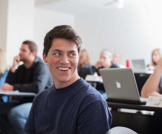 Student sitting in a lecture classroom.